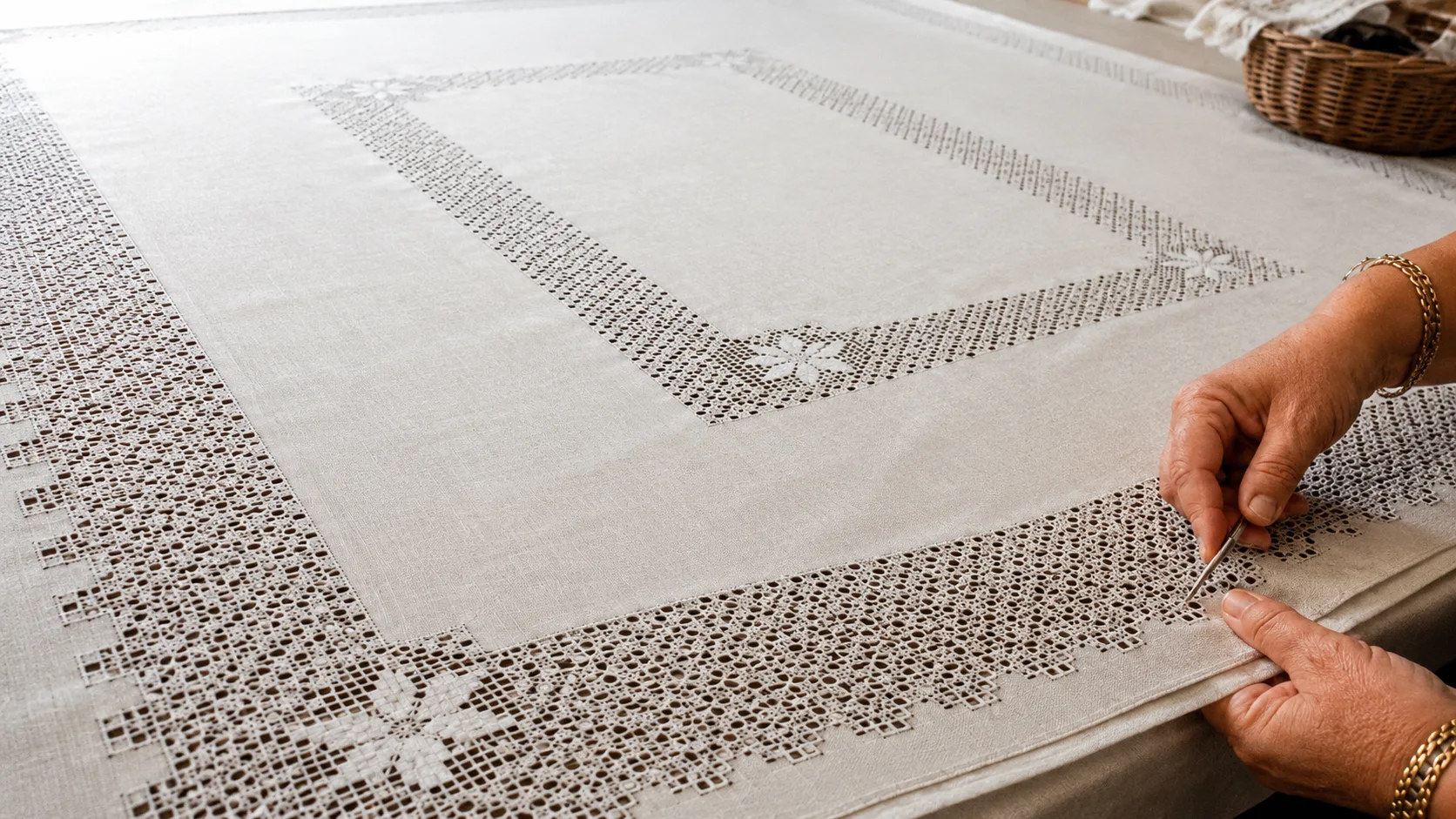 Artesana elaborando una pieza de calado tradicional sobre lino en Fuerteventura, ejemplo de la artesanía textil y la moda artesanal de Canarias.